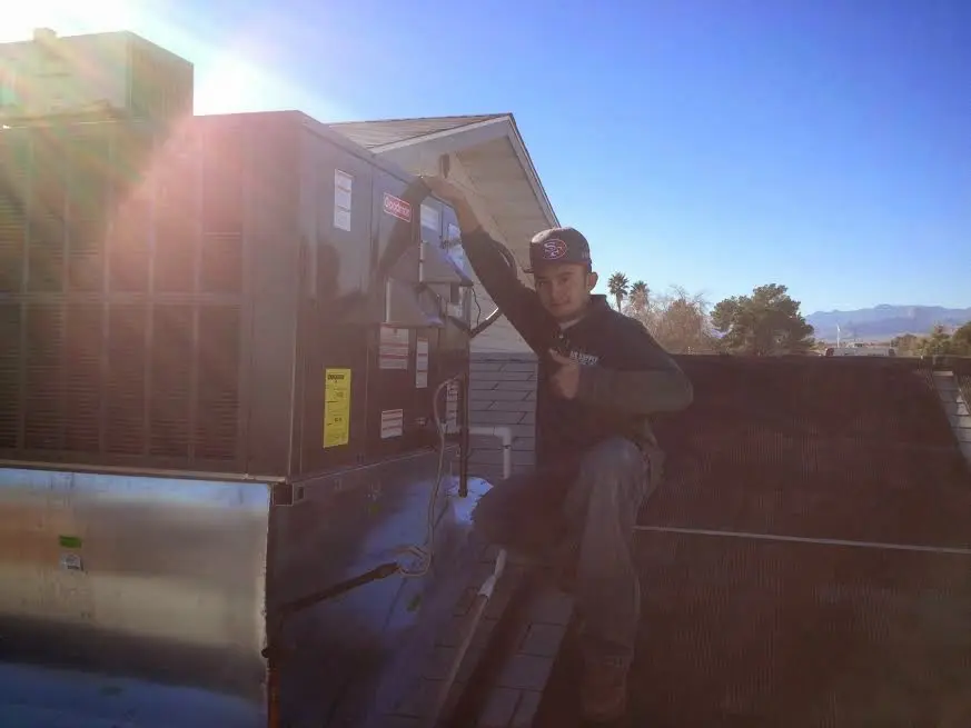 HVAC technician performing Heat Pump Repair on a rooftop unit in McKinleyville